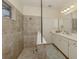 Bathroom with walk-in shower and double vanity at 12198 Wakulla Pl, Venice, FL 34293