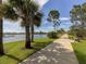 Scenic walkway with lake views, lush landscaping, and shaded benches at 12198 Wakulla Pl, Venice, FL 34293