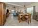 Bright dining area with wooden table and chairs, adjacent to living room at 12198 Wakulla Pl, Venice, FL 34293