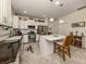 Open kitchen with white cabinets, granite countertops, and a large island at 12198 Wakulla Pl, Venice, FL 34293