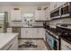 Spacious kitchen with white cabinets, granite counters, and island at 12198 Wakulla Pl, Venice, FL 34293