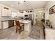 Modern kitchen with white cabinets, granite countertops, and stainless steel appliances at 12198 Wakulla Pl, Venice, FL 34293