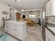 Open concept kitchen with island and view into dining area at 12198 Wakulla Pl, Venice, FL 34293