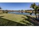 Serene backyard oasis with a lake view and lush lawn at 12198 Wakulla Pl, Venice, FL 34293