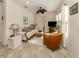 Cozy living room with tiled floors, comfortable seating, and a TV at 12198 Wakulla Pl, Venice, FL 34293