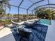 Relaxing pool area with rocking chairs and a view at 12198 Wakulla Pl, Venice, FL 34293