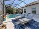 Spacious pool area with lounge chairs and a blue rug at 12198 Wakulla Pl, Venice, FL 34293