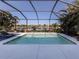 Refreshing screened-in pool overlooking a lake at 12198 Wakulla Pl, Venice, FL 34293