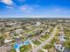 Aerial view of community, showcasing homes, waterways, and roads at 1236 Pinebrook Way, Venice, FL 34285