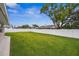 Spacious backyard with lush grass and a white vinyl fence at 1236 Pinebrook Way, Venice, FL 34285