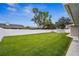 Large backyard with lush green grass and a white vinyl fence at 1236 Pinebrook Way, Venice, FL 34285