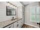 Updated bathroom with granite countertop, modern vanity, and shiplap accent wall at 1236 Pinebrook Way, Venice, FL 34285