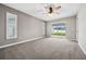 Bright bedroom featuring carpet floors, sliding glass doors, and a ceiling fan at 1236 Pinebrook Way, Venice, FL 34285