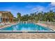 Inviting community pool with lounge chairs and surrounding landscaping at 1236 Pinebrook Way, Venice, FL 34285