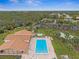 Aerial view of community pool, clubhouse, and surrounding landscape at 1236 Pinebrook Way, Venice, FL 34285