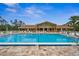Inviting community pool with a clubhouse and lounge chairs at 1236 Pinebrook Way, Venice, FL 34285