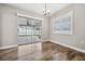 Bright dining area with wood-look floors, plantation shutters, and sliding glass doors at 1236 Pinebrook Way, Venice, FL 34285