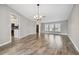 Open dining room with wood-look floors and views into the kitchen area at 1236 Pinebrook Way, Venice, FL 34285