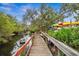 Wooden community dock offering scenic views at 1236 Pinebrook Way, Venice, FL 34285