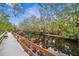 Serene waterfront walkway with wooden dock at 1236 Pinebrook Way, Venice, FL 34285