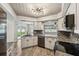 Modern kitchen with granite countertops and stainless steel appliances at 1236 Pinebrook Way, Venice, FL 34285