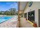 Community pool with lounge chairs and nearby clubhouse at 1236 Pinebrook Way, Venice, FL 34285
