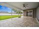 Spacious screened patio with tile flooring, ceiling fan and access to backyard at 1236 Pinebrook Way, Venice, FL 34285