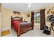 Bedroom with a wooden bed frame and red bedding at 12458 Birtle Ave, Port Charlotte, FL 33981