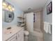 Bathroom with shower/tub, vanity, and linen shelving at 1300 Indus Rd, Venice, FL 34293