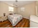Bedroom with a double bed, side table, and wood flooring at 1300 Indus Rd, Venice, FL 34293