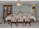 Formal dining room with a large table, floral chairs, and a wooden china cabinet at 1300 Indus Rd, Venice, FL 34293