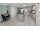 Kitchen boasts gray cabinets, granite counters, and ample workspace at 1300 Indus Rd, Venice, FL 34293