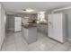 Kitchen with gray cabinets, granite countertops, and an island at 1300 Indus Rd, Venice, FL 34293