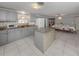 Open kitchen with granite counters, gray cabinets & island at 1300 Indus Rd, Venice, FL 34293