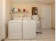 Laundry room with washer, dryer, and hot water heater at 1300 Indus Rd, Venice, FL 34293