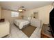 Main bedroom with a large bed, plenty of natural light, and tiled floors at 1300 Indus Rd, Venice, FL 34293