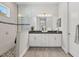 Modern bathroom with double vanity, large shower, and pebble floor at 13072 Steinhatchee Loop, Venice, FL 34293