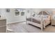 Main bedroom with a king-size bed and light-colored decor at 13072 Steinhatchee Loop, Venice, FL 34293