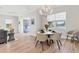 Bright dining room with a round table and chairs, overlooking a water view at 13072 Steinhatchee Loop, Venice, FL 34293