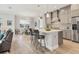 Open concept kitchen with island seating, dining area, and stainless steel appliances at 13072 Steinhatchee Loop, Venice, FL 34293