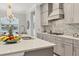 Modern kitchen features a large island with a double sink and breakfast bar at 13072 Steinhatchee Loop, Venice, FL 34293