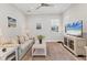 Living room with comfy sofa, TV, and large window providing natural light at 13072 Steinhatchee Loop, Venice, FL 34293