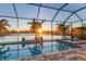 Enclosed pool and spa with sunset view at 13072 Steinhatchee Loop, Venice, FL 34293