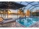 Enclosed pool and spa overlooking a lake at sunset at 13072 Steinhatchee Loop, Venice, FL 34293