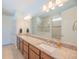 Double vanity bathroom with granite countertops and a large walk-in shower at 13164 Rinella St, Venice, FL 34293