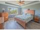Bright bedroom with king-size bed and wood furniture, offering natural light at 13164 Rinella St, Venice, FL 34293