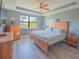 Bright bedroom with king-size bed and wood furniture, offering natural light at 13164 Rinella St, Venice, FL 34293