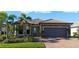 Single story home with a two-car garage and landscaped front yard at 13164 Rinella St, Venice, FL 34293