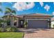 Single-story home with stone accents, tile roof, and two-car garage at 13164 Rinella St, Venice, FL 34293