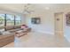 Spacious living room featuring a large sectional sofa and a flat-screen TV at 13164 Rinella St, Venice, FL 34293